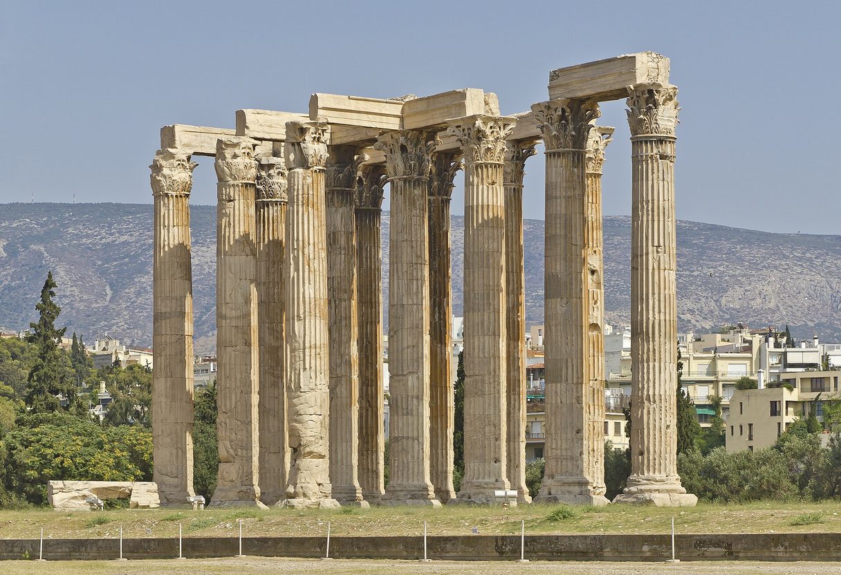Towering Corinthian columns of the Temple of Olympian Zeus with remaining architrave, hills of Athens in the background