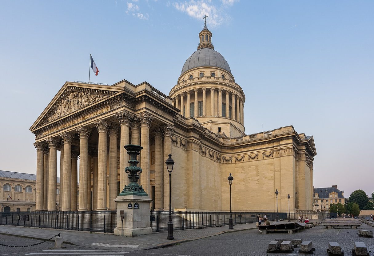 Panthéon in Paris with its columned portico and dome under a clear morning sky, lamp posts in the square