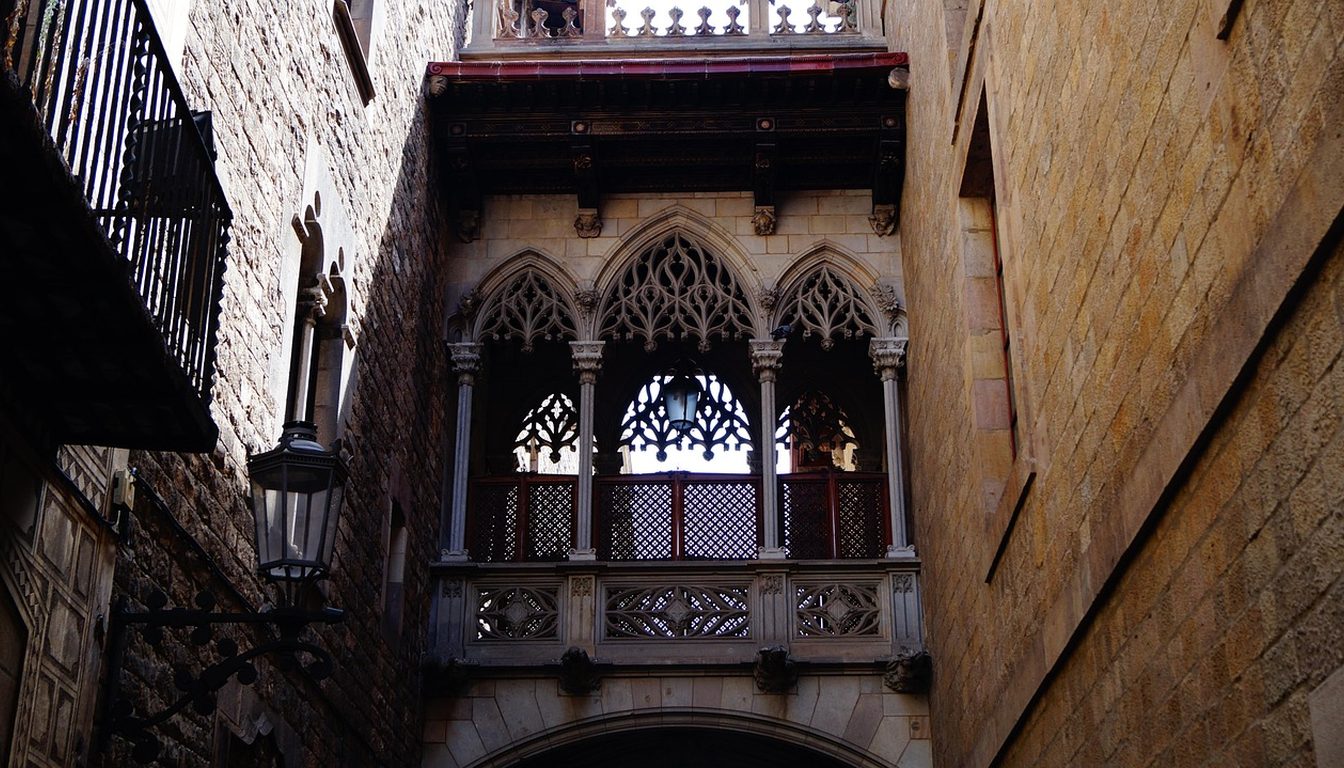 Neo-Gothic bridge of Carrer del Bisbe spanning a narrow stone street in Barcelona's Gothic Quarter