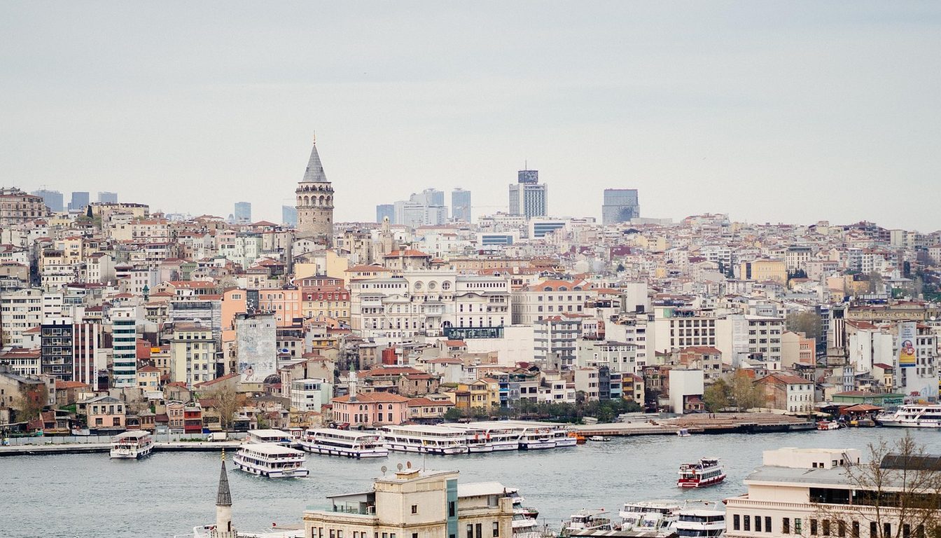 White ferries on the Golden Horn below Karaköy's hillside buildings and Galata Tower in Istanbul