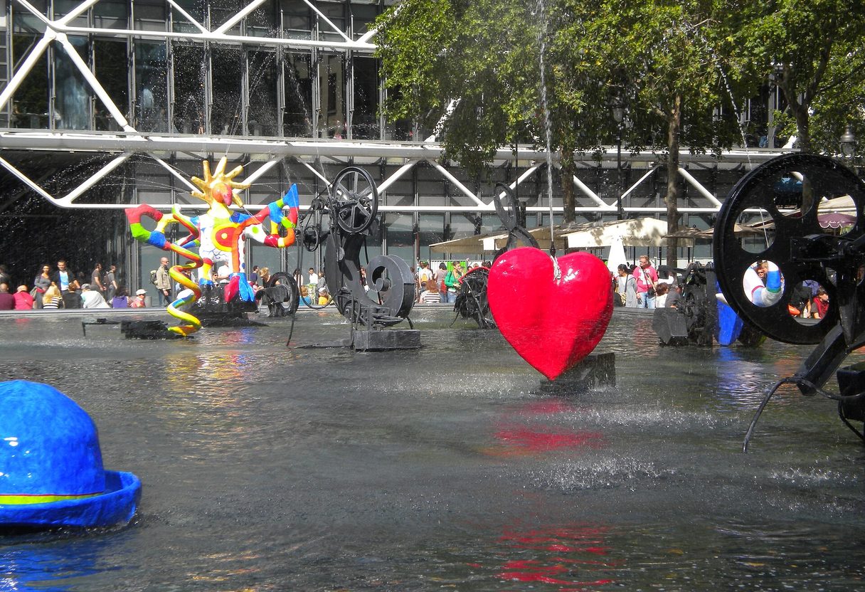 Red heart, firebird and black kinetic machines in the Stravinsky Fountain, with the Centre Pompidou's exposed structure behind
