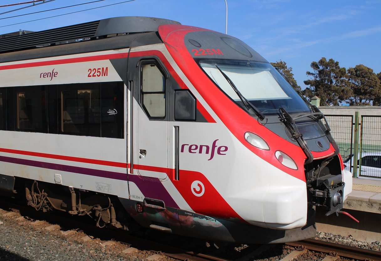 Close-up of a red-and-white Renfe Cercanías Civia commuter train at a platform